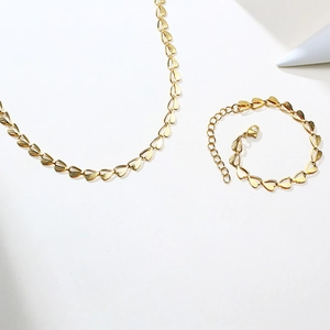 Golden stainless steel necklace and bracelet set with textured hollow heart links
