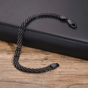 Close-up of a men's black stainless steel three-row mesh link bracelet with lobster clasp