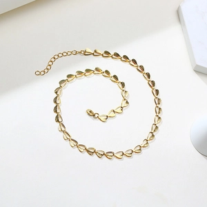 Golden stainless steel heart link chain necklace with intricate brushed texture finish