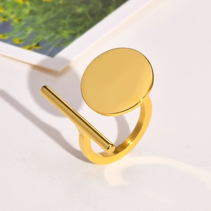 Detailed macro view of the geometric gold-plated stainless steel ring with polished finish