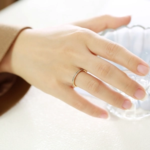 Detail of minimalist gold plated slim ring featuring micro-pave cubic zirconia stones