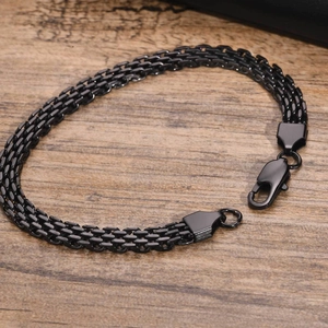 Detailed close-up of a black stainless steel mesh chain bracelet with a lobster clasp
