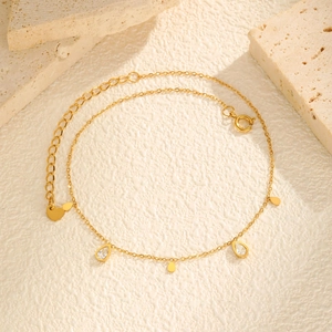 Gold stainless steel anklet with water drop zircon tassels on a minimalist stone base