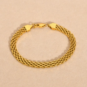 Macro shot of three-row gold mesh chain bracelet showing intricate weave and lobster clasp