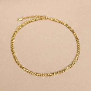 Detail of golden wheat chain necklace featuring K18 engraved tag and lobster clasp