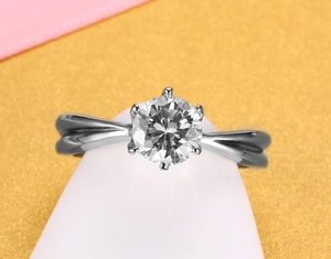 Detailed view of a six-prong classic silver wedding ring with a twisted band design