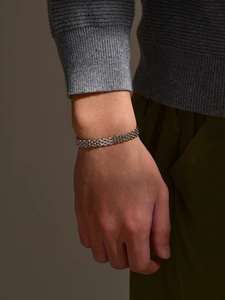 Detail of silver stainless steel mesh bracelet showing the masculine watch-band style links