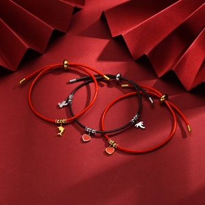 Adjustable red and black woven bracelets with dolphin, heart, and bird charms