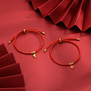 Adjustable red braided rope bracelet set with gold dolphin and heart pendants