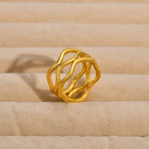 Detail of creative gold triple-layer wavy stainless steel ring on velvet tray