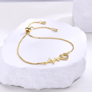 Adjustable gold heart and heartbeat bracelet with sparkling zircon on white stone