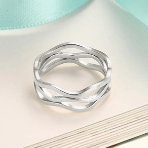 Close-up of triple-layered wavy stainless steel ring with elegant hollow streamline design
