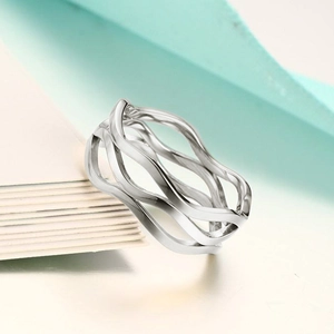 Macro shot of silver multi-layer wavy stainless steel rings with minimalist design