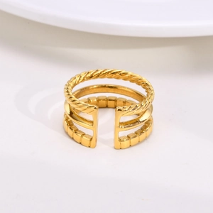 Close-up of golden multi-layer open ring featuring twist and textured band designs