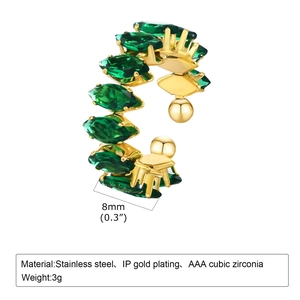 Detail of gold IP plated cuff earring featuring marquise-cut green cubic zirconia stones