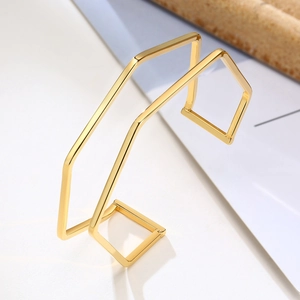 Detailed view of a gold geometric polygon open cuff bracelet with polished finish