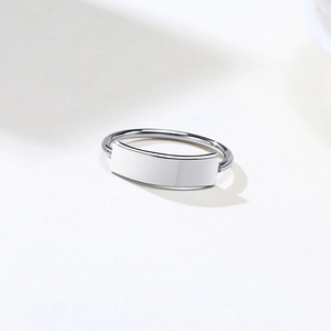 Macro shot of minimalist silver stainless steel ring with flat engravable rectangular plate