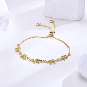 Detailed view of adjustable gold leaf bracelet featuring pavé zircon and pull-string clasp