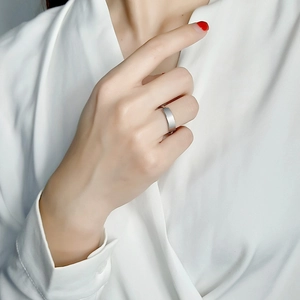 Detail of silver matte flat top stainless steel ring on model in minimalist style