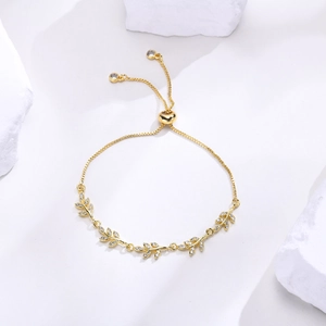 Detail of adjustable gold leaf bracelet with cubic zirconia on white stones