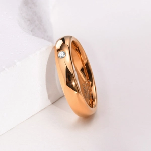 Macro shot of 4mm rose gold tungsten ring with single inset cubic zirconia and hallmark