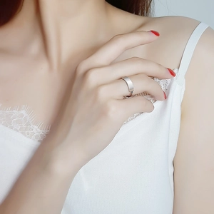 Close-up of minimalist silver band ring with rectangular flat surface on finger