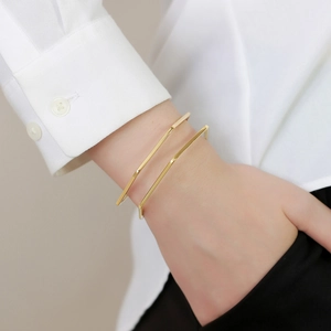 Minimalist gold-plated C-shaped geometric open cuff bracelets for women shown on model