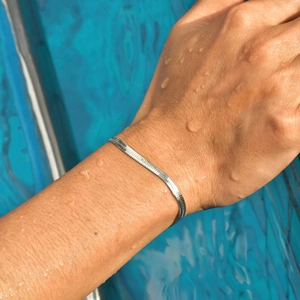 Waterproof silver flat snake chain bracelet for men and women on a wet wrist