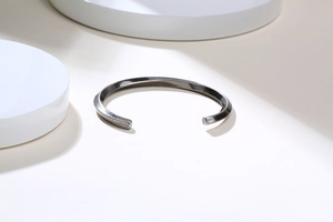 Macro shot of twisted vintage stainless steel cuff bracelet with matte antique finish