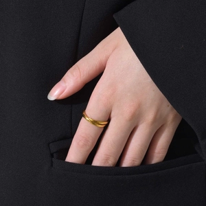 Three-intertwined minimalist bands ring in gold finish worn on finger for fashion