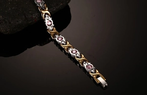 Macro shot of titanium magnetic bracelet with pink crystals and cubic zirconia in two-tone finish
