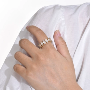 Golden ring with marquise-cut marquise cubic zirconia stones shown on a model hand