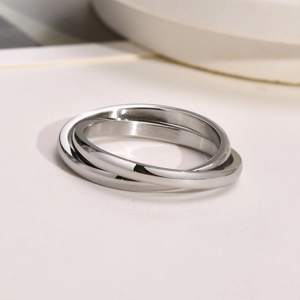 Close-up of interlocking silver triple band ring with a polished stainless steel finish