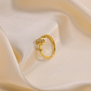 Elegant 18K gold plated tulip open ring with sparkling crystals on silk background