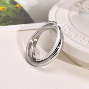 Macro shot of interlocking silver-tone polished rings showing smooth mirror finish detail