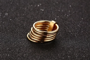 Detailed view of polished gold stacked ring set with six bands and rectangular clasp