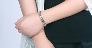 Close-up of titanium steel magnetic bracelet with purple zircons worn on a wrist