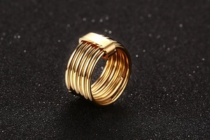 Detailed view of polished gold six-band stainless steel ring with metal clasp connector