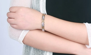 Elegant magnetic steel bracelet featuring pink gems and clear zircons on model wrist