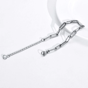 Detailed view of titanium paperclip chain bracelet with lobster clasp and zircon drop