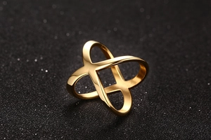 Detailed view of polished gold geometric X-shaped double-layer cross ring jewelry
