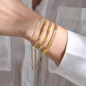 Gold stainless steel snake chain bracelet set with four adjustable widths worn on wrist