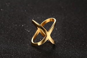 Macro shot of polished gold-plated criss-cross X ring with a minimalist metal design