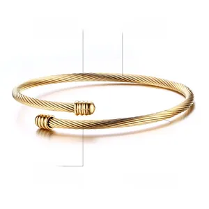 Detail of 3mm gold twisted cable cuff bracelet in polished stainless steel