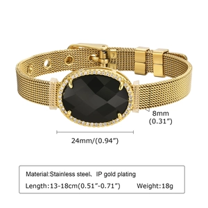 Détail d'un bracelet en maille d'acier doré avec une pierre noire et des cristaux brillants