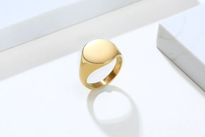 Macro view of minimalist 18K gold plated stainless steel signet ring with a smooth finish