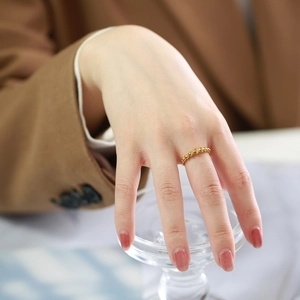 Minimalist gold beaded ball ring for women styled on finger with elegant aesthetic