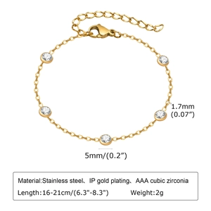 Macro view of gold stainless steel chain with five clear cubic zirconia stones