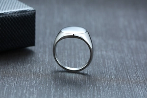 Macro shot of polished silver stainless steel signet ring with oval flat top surface