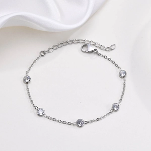 Detailed shot of silver steel bracelet featuring five bezel-set white cubic zirconia stones